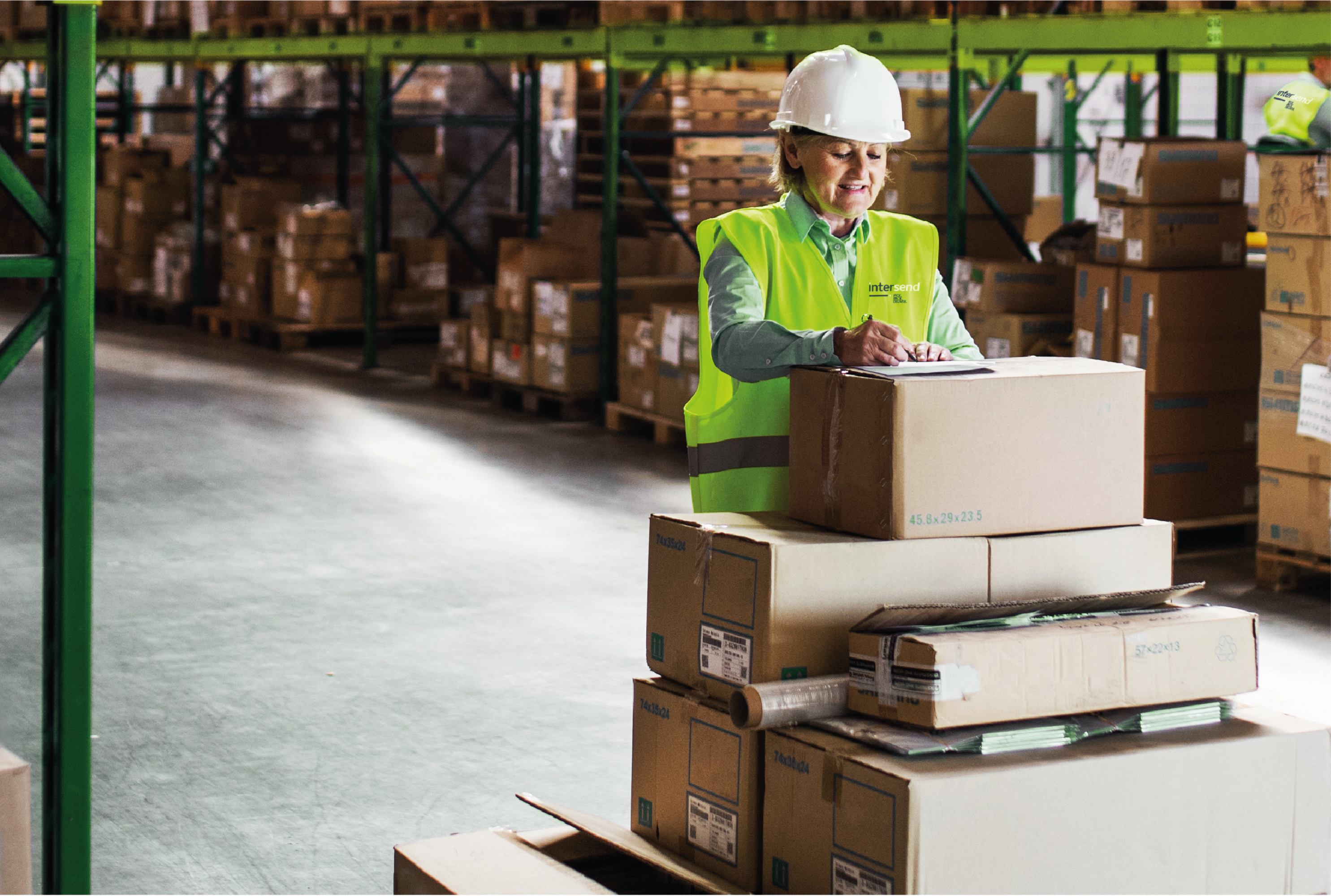 A woman packing boxes in a warehouse